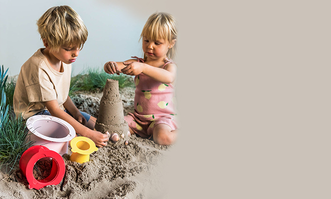 Kinder bauen eine Sandburg